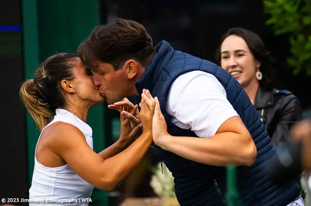 Natalija Stevanovic kisses her husband Nikola Stevanovic after defeating Karolina Pliskova at Wimbledon 2023