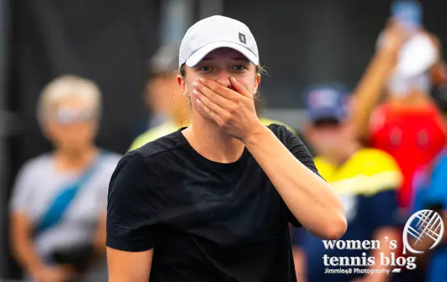Iga Swiatek covers her mouth with her hand during a practice in Montreal