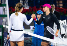 Anna Kalinskaya and Iga Swiatek shake hands after the Dubai semifinal