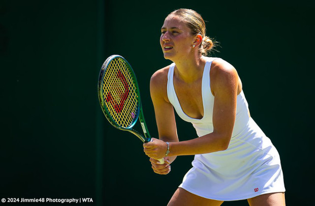 Marta Kostyuk in white Wilson tennis dress at Wimbledon