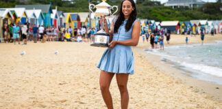 Madison Keys poses with her Australian Open trophy on the beach