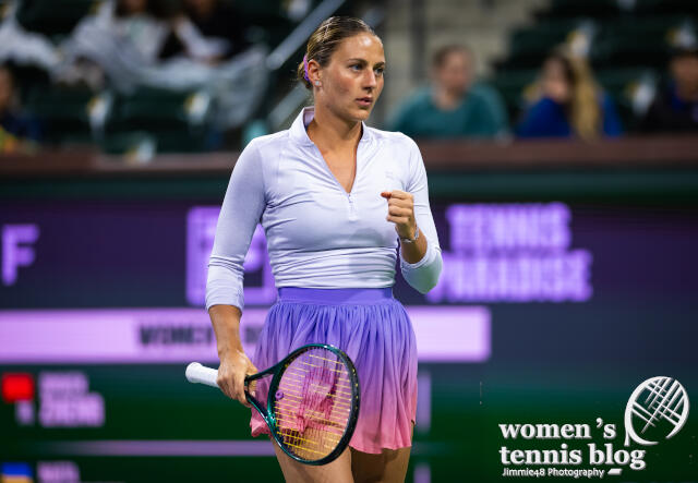 Marta Kostyuk's purple Wilson dress covered with a long-sleeve top at Indian Wells